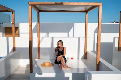 Woman scrolling her feed on her smartphone while being on vacation