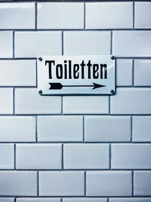 Closeup vertical shot of a toilet sign with a german writing